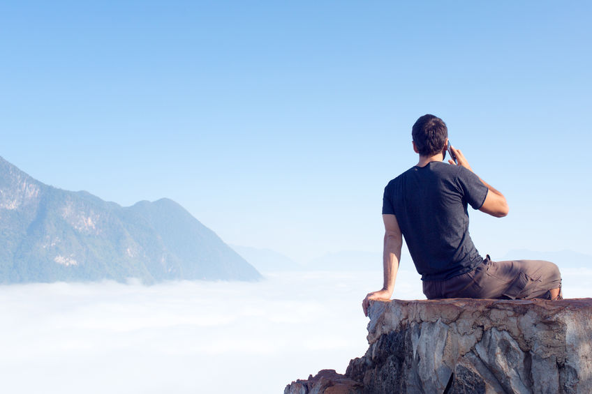 80155671 - man in travel in the mountains use mobile phone