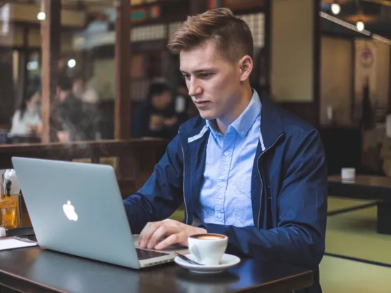 A man working remotely at a cafe.
